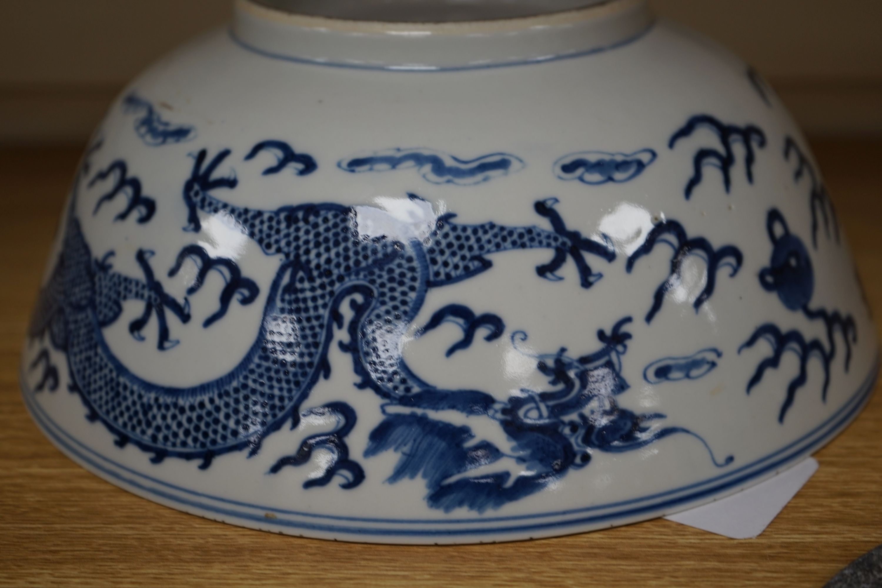 A Chinese blue and white ‘dragon’ bowl, Kangxi mark, late 19th century 25cm